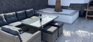 1340big-playa-blanca-villa-arabella-outdoor-lounging-area-with-wine-and-glasses-on-table
